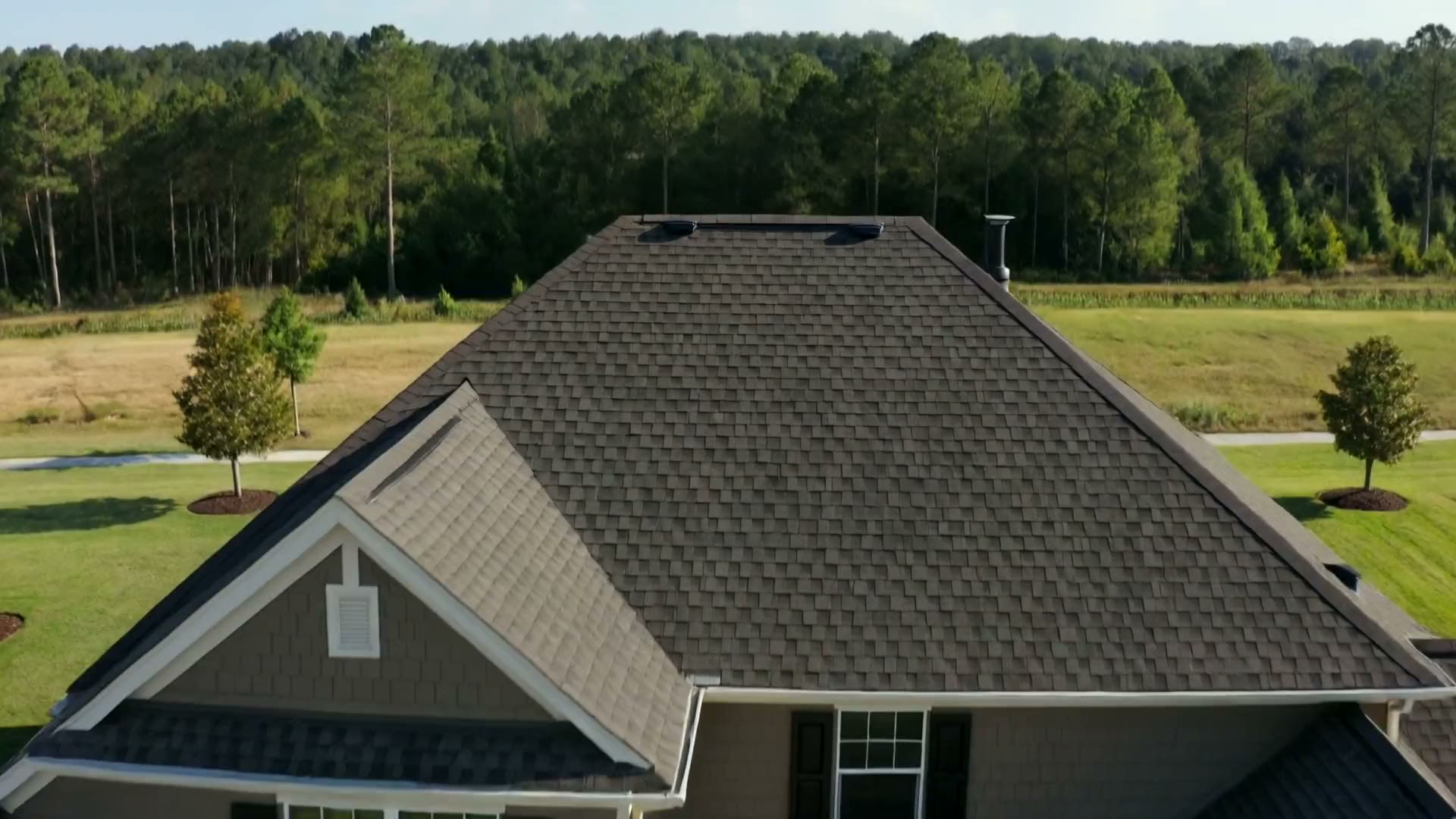 Aerial drone view of an upscale home with a new roof